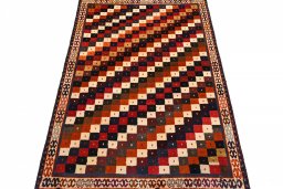 Surface texture of 2000s Persian Gabbeh rug with natural Wool and intricate pattern