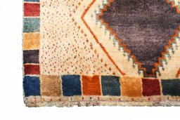 Corner detail of 2000s Persian Gabbeh rug showing border pattern and Wool pile
