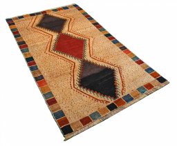 Corner detail of 2000s Persian Gabbeh rug showing border pattern and Wool pile