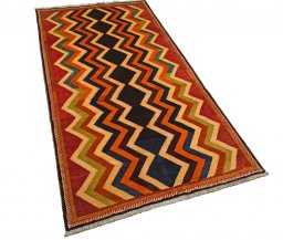 Corner detail of 2000s Persian Gabbeh rug showing border pattern and Wool pile