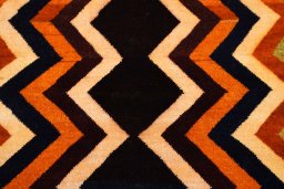 Backside of handmade 2000s Persian Gabbeh rug showing knot structure and weave density