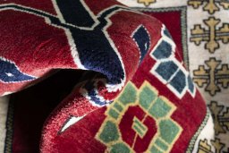 Corner detail of 2000s Persian Gabbeh rug showing border pattern and Wool pile