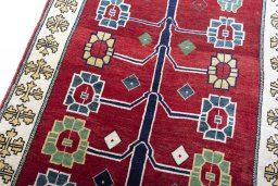 Backside of handmade 2000s Persian Gabbeh rug showing knot structure and weave density