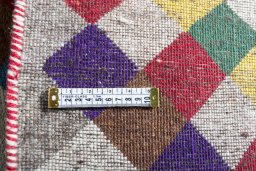Corner detail of 2000s Persian Gabbeh rug showing border pattern and Wool pile