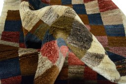 Corner detail of 2000s Persian Gabbeh rug showing border pattern and Wool pile