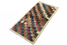 Corner detail of 2000s Persian Gabbeh rug showing border pattern and Wool pile