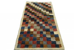 Surface texture of 2000s Persian Gabbeh rug with natural Wool and intricate pattern