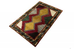 Corner detail of 2000s Persian Gabbeh rug showing border pattern and Wool pile