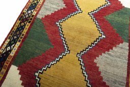 Backside of handmade 2000s Persian Gabbeh rug showing knot structure and weave density