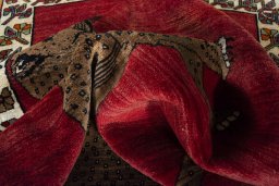 Corner detail of 2000s Persian Gabbeh rug showing border pattern and Wool pile