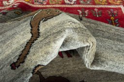 Corner detail of 2000s Persian Gabbeh rug showing border pattern and Wool pile