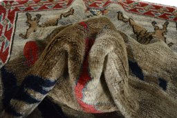 Corner detail of 2000s Persian Gabbeh rug showing border pattern and Wool pile
