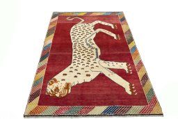 Surface texture of 2000s Persian Gabbeh rug with natural Wool and intricate pattern