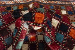 Corner detail of 2000s Persian Gabbeh rug showing border pattern and Wool pile