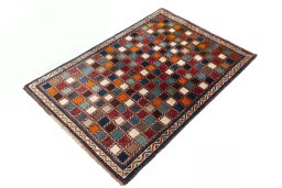 Corner detail of 2000s Persian Gabbeh rug showing border pattern and Wool pile