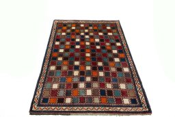 Surface texture of 2000s Persian Gabbeh rug with natural Wool and intricate pattern