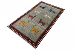 Corner detail of 2000s Persian Gabbeh rug showing border pattern and Wool pile