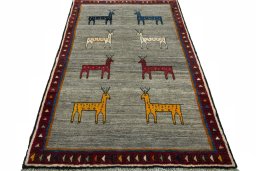 Surface texture of 2000s Persian Gabbeh rug with natural Wool and intricate pattern