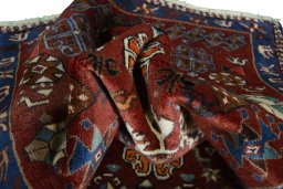 Corner detail of 2000s Persian Gabbeh rug showing border pattern and Wool pile