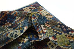 Corner detail of 2000s Persian Gabbeh rug showing border pattern and Wool pile