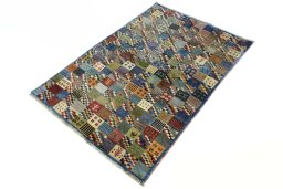Corner detail of 2000s Persian Gabbeh rug showing border pattern and Wool pile