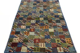 Surface texture of 2000s Persian Gabbeh rug with natural Wool and intricate pattern