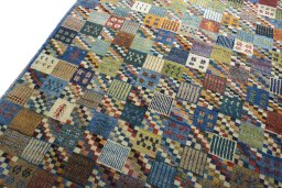 Backside of handmade 2000s Persian Gabbeh rug showing knot structure and weave density