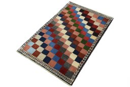 Corner detail of 2000s Persian Gabbeh rug showing border pattern and Wool pile