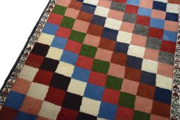 Backside of handmade 2000s Persian Gabbeh rug showing knot structure and weave density