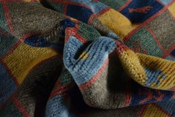 Corner detail of 2000s Persian Gabbeh rug showing border pattern and Wool pile