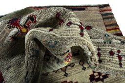 Corner detail of 2000s Persian Gabbeh rug showing border pattern and Wool pile