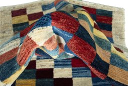 Corner detail of New Persian Gabbeh rug showing border pattern and Wool pile