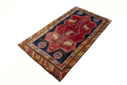 Corner detail of 2000s Persian Gabbeh rug showing border pattern and Wool pile