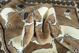 Corner detail of 2000s Persian Gabbeh rug showing border pattern and Wool pile