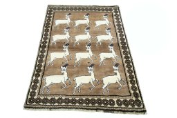 Surface texture of 2000s Persian Gabbeh rug with natural Wool and intricate pattern