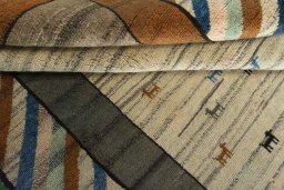 Corner detail of 2000s Persian Gabbeh rug showing border pattern and Wool pile
