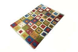 Corner detail of 2000s Persian Gabbeh rug showing border pattern and Wool pile
