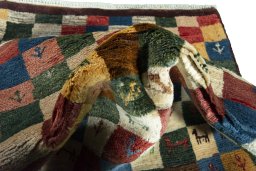 Corner detail of 2000s Persian Gabbeh rug showing border pattern and Wool pile