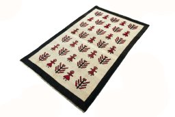 Corner detail of 2000s Persian Gabbeh rug showing border pattern and Wool pile
