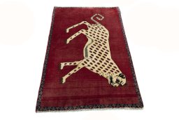 Surface texture of 2000s Persian Gabbeh rug with natural Wool and intricate pattern
