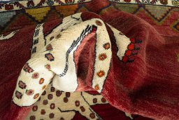 Corner detail of 2000s Persian Gabbeh rug showing border pattern and Wool pile