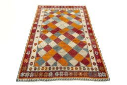 Surface texture of 2000s Persian Gabbeh rug with natural Wool and intricate pattern