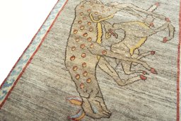 Backside of handmade 2000s Persian Gabbeh rug showing knot structure and weave density