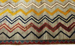 Backside of handmade 2000s Persian Gabbeh rug showing knot structure and weave density