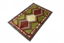 Corner detail of 2000s Persian Gabbeh rug showing border pattern and Wool pile