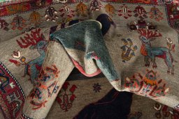 Corner detail of 2000s Persian Gabbeh rug showing border pattern and Wool pile