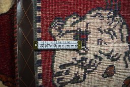 Corner detail of 2000s Persian Gabbeh rug showing border pattern and Wool pile