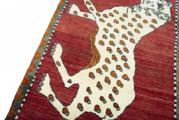 Backside of handmade 2000s Persian Gabbeh rug showing knot structure and weave density