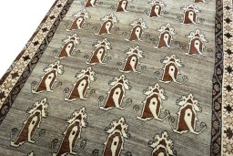 Surface texture of 2000s Persian Gabbeh rug with natural Wool and intricate pattern