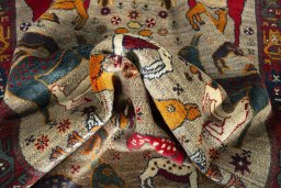 Corner detail of 2000s Persian Gabbeh rug showing border pattern and Wool pile